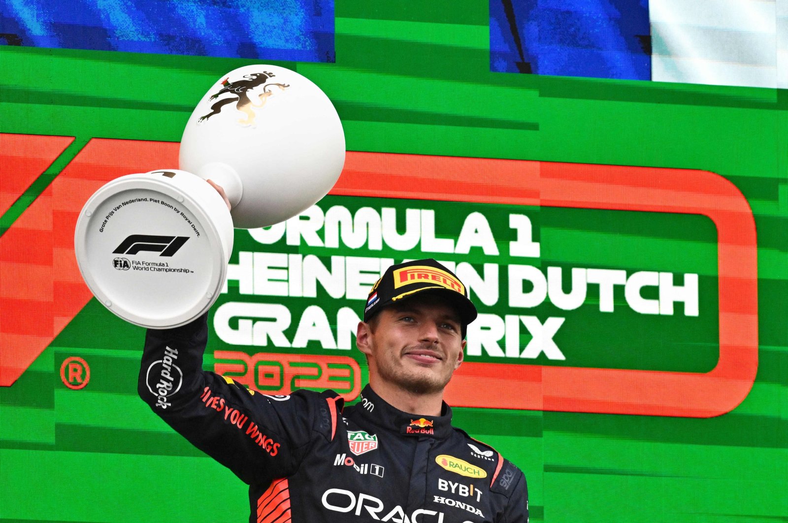 Red Bull Racing's Dutch driver Max Verstappen celebrates with the trophy on the podium after winning the Dutch Formula One Grand Prix race at The Circuit Zandvoort, Zandvoort, Netherlands, Aug. 27, 2023. (AFP Photo)