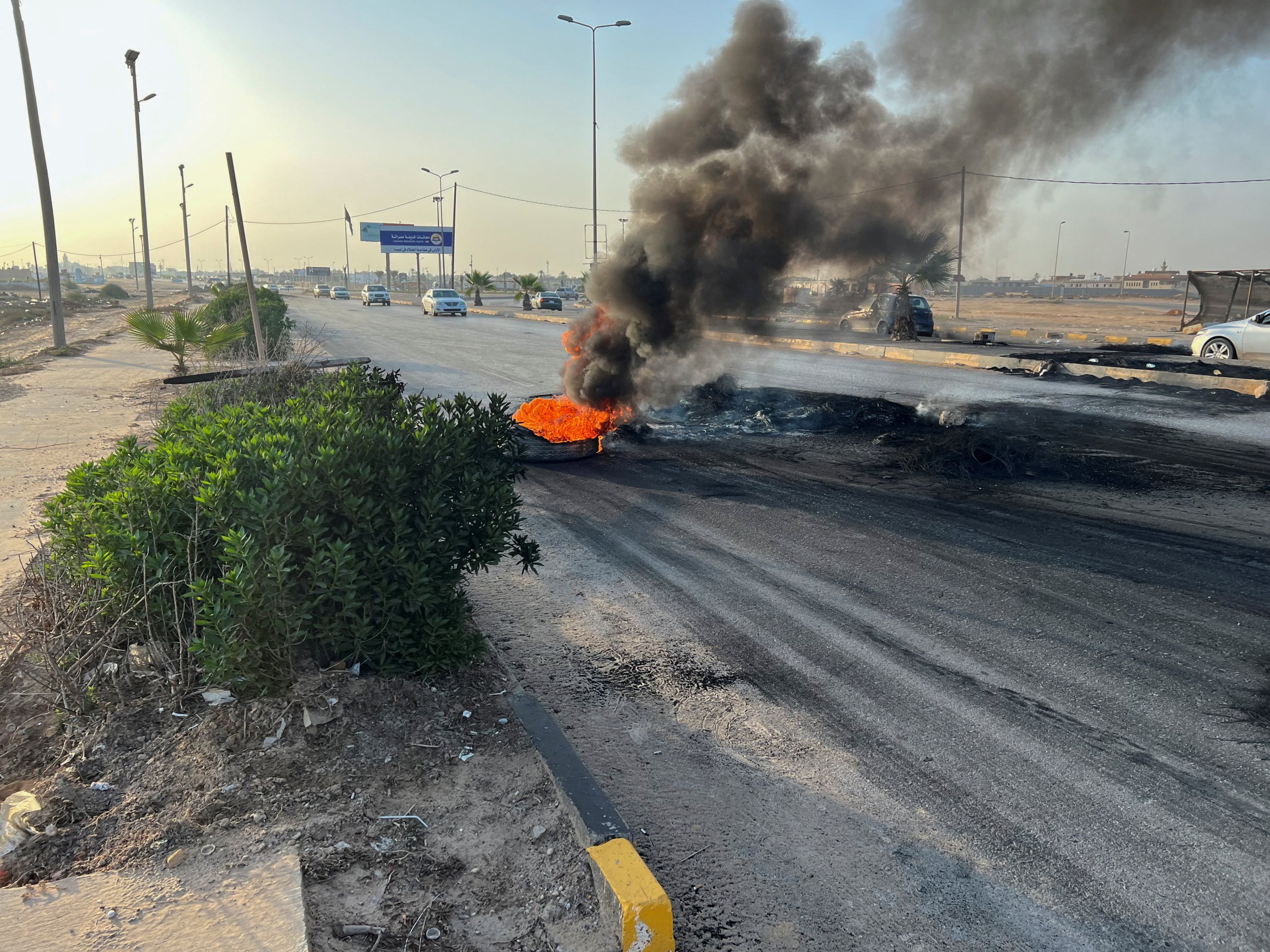 289373 Tires burn on the road as people protest against the meeting of foreign ministers of Libya and Israel, Tripoli, Libya, Aug. 28, 2023. (Reuters Photo)
