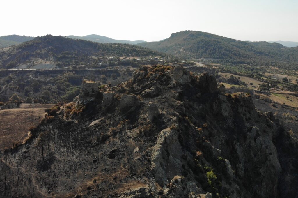 A drone image shows 2,500-year-old Atikhisar Castle, which was damaged by a fire, Çanakkale, Türkiye, Aug. 30, 2023. (IHA Photo)