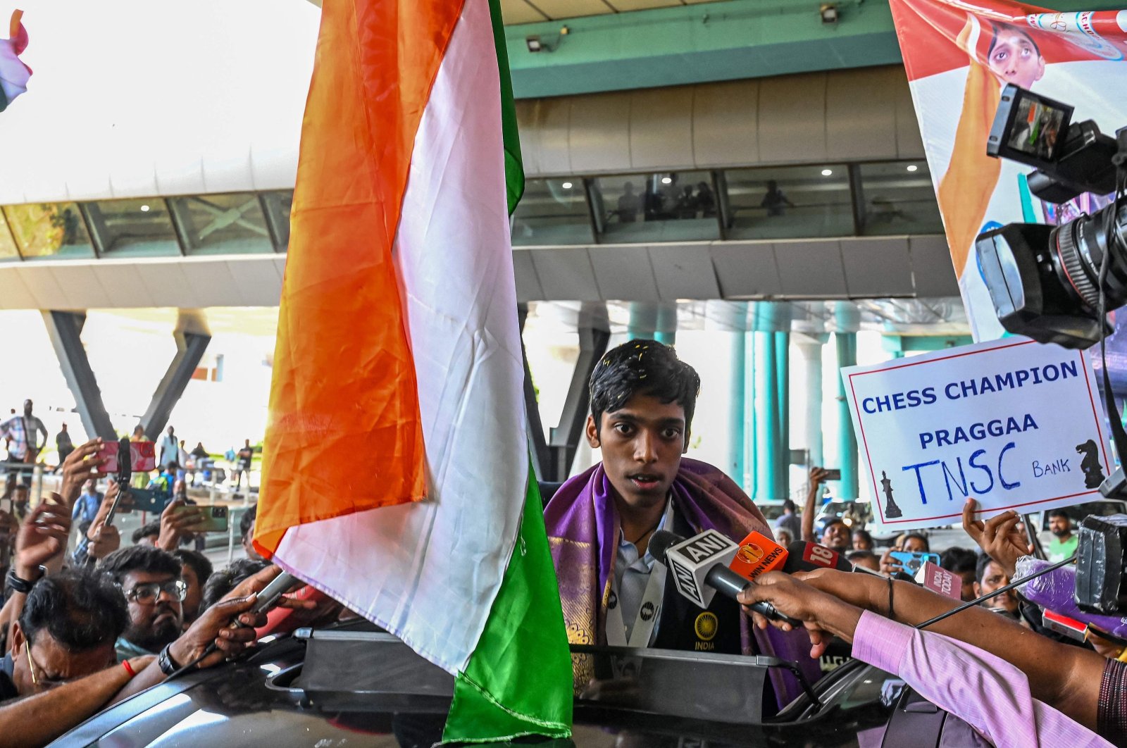 India's chess grandmaster and silver medallist Rameshbabu Praggnanandhaa, responds to a television media personnel as he is welcomed upon his return from the FIDE Chess World Cup in Baku, at the Chennai International airport, Chennai, India, Aug. 30, 2023. (AFP Photo)
