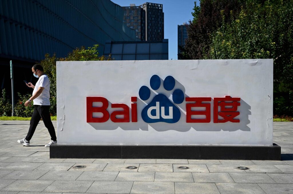 An employee walks past the company logo at Baidu's headquarters in Beijing, China, Sept. 6, 2022. (AFP Photo)