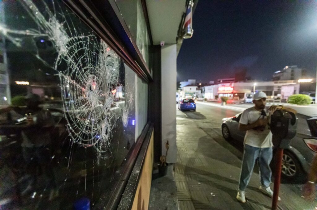 The front glass of the store is seen shattered, as protesters attacked the hair salon that belongs to a migrant, Limassol, Greek Cypriot administration, Sep. 2, 2023. (Rueters Photo)