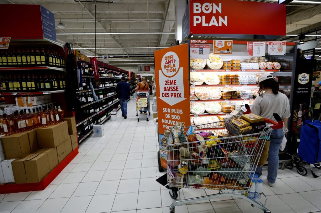 A sign reading "Anti-inflation challenge, second price cut" near shelves at a supermarket in Nice, France, June 15, 2023. (Reuters Photo)
