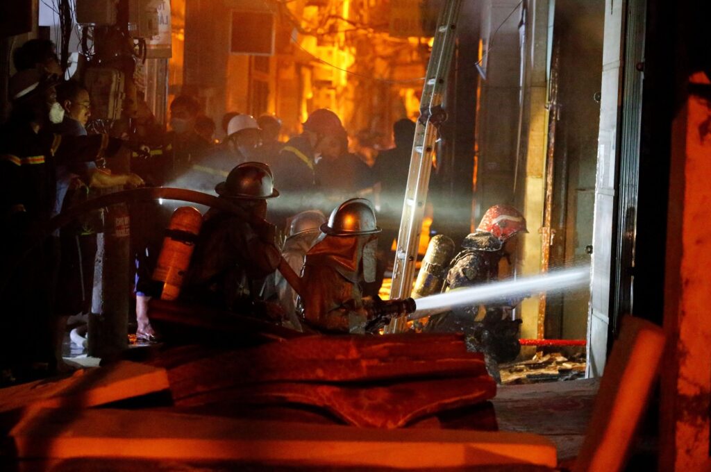 Firefighters work to put out a fire and rescue people at an apartment block in Hanoi, Vietnam, Sept. 13, 2023. (AFP Photo)