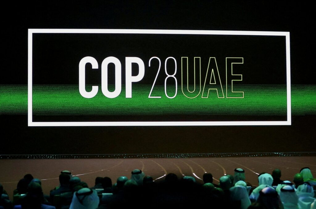 The "COP28 UAE" logo is displayed on the screen during the opening ceremony of Abu Dhabi Sustainability Week (ADSW) under the theme of "United on Climate Action Toward COP28," in Abu Dhabi, UAE, Jan. 16, 2023. (Reuters Photo)