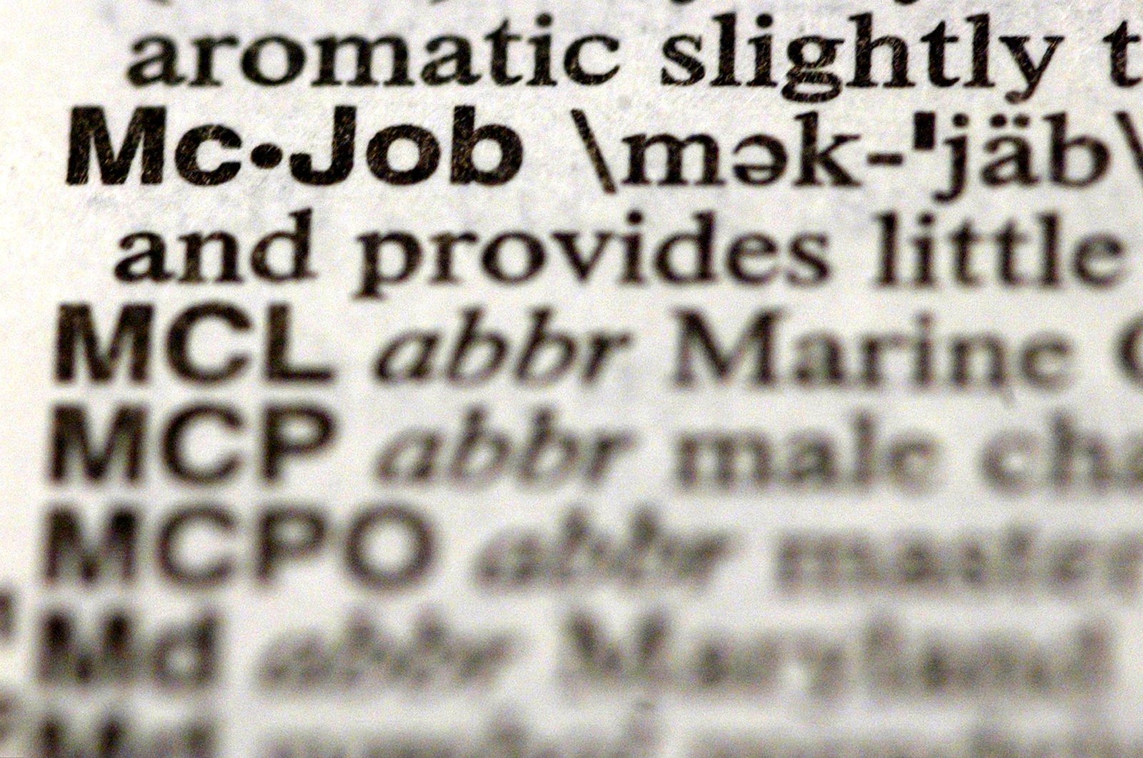 The word "McJob" is seen in a Merriam-Webster's Collegiate Dictionary in a bookstore Illinois, U.S., Nov. 10, 2003. (Getty Images Photo)