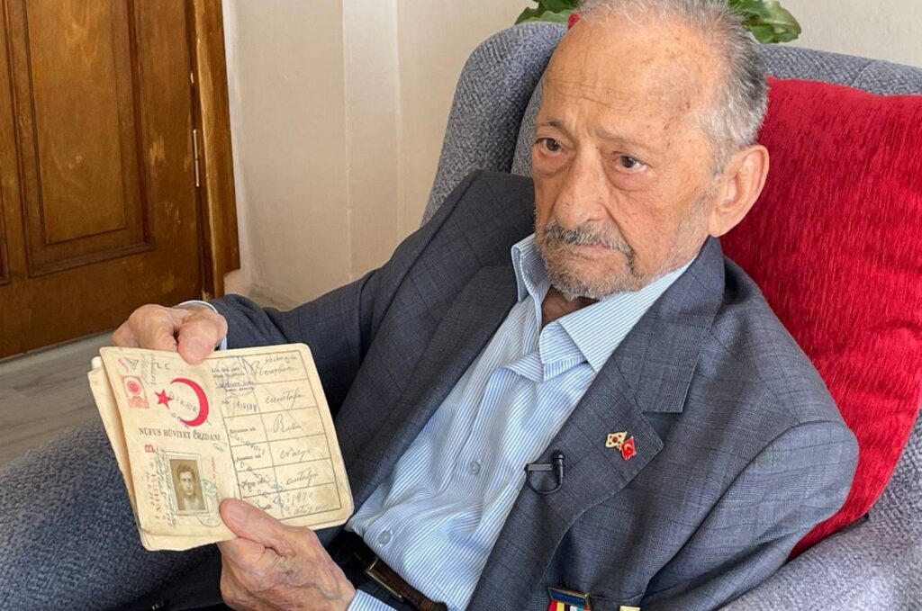 Mustafa Reşberoğlu, a Korean War veteran, poses with his old ID card, Sarıyer, Istanbul, Türkiye, Sept. 29, 2023. (AA Photo)