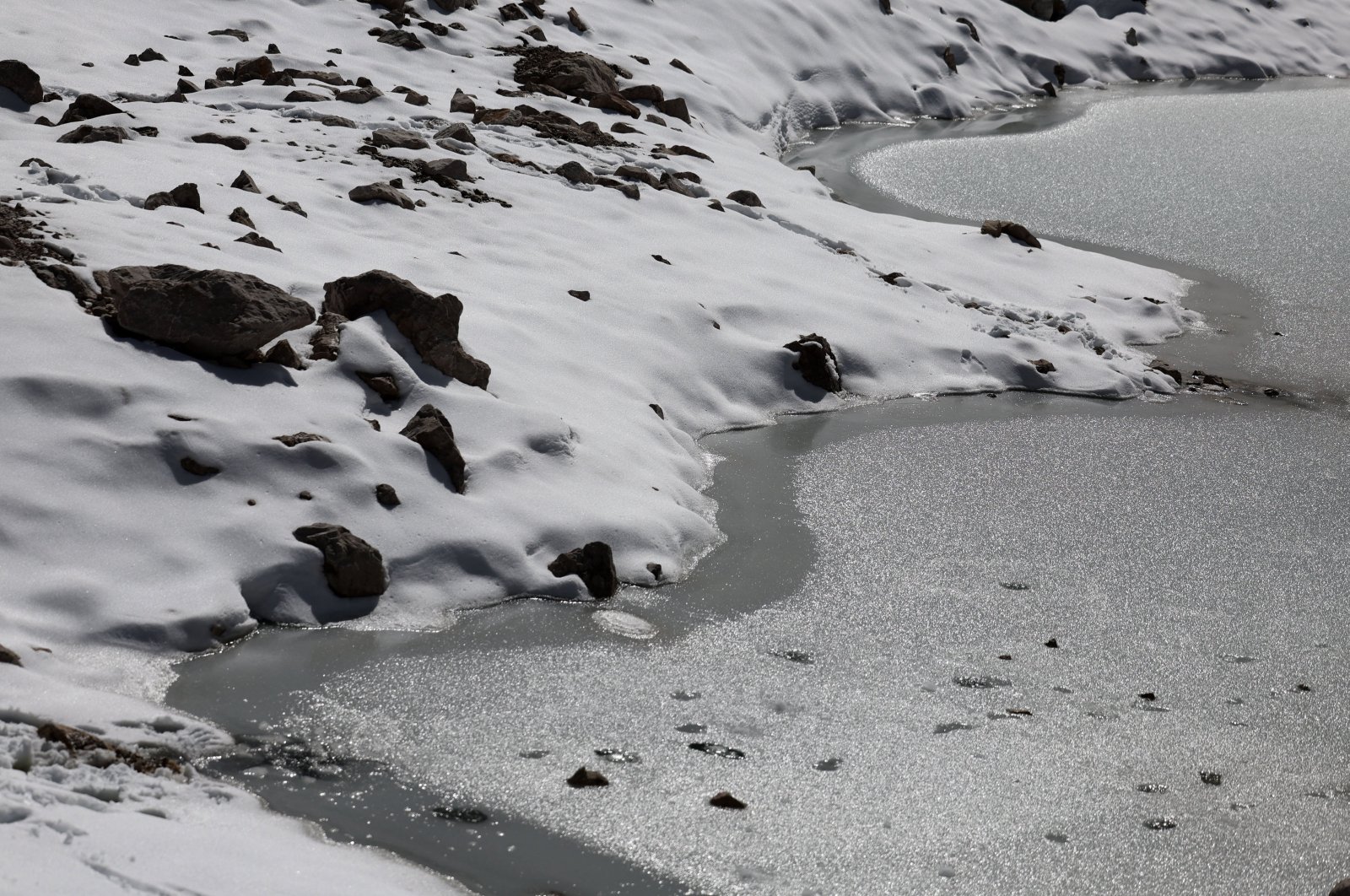 Melting ice of a small pool of the Schneeferner Glacier below Germany's highest mountain Zugspitze, near Garmisch-Partenkirchen, Germany, Sept. 26, 2023. (EPA Photo)