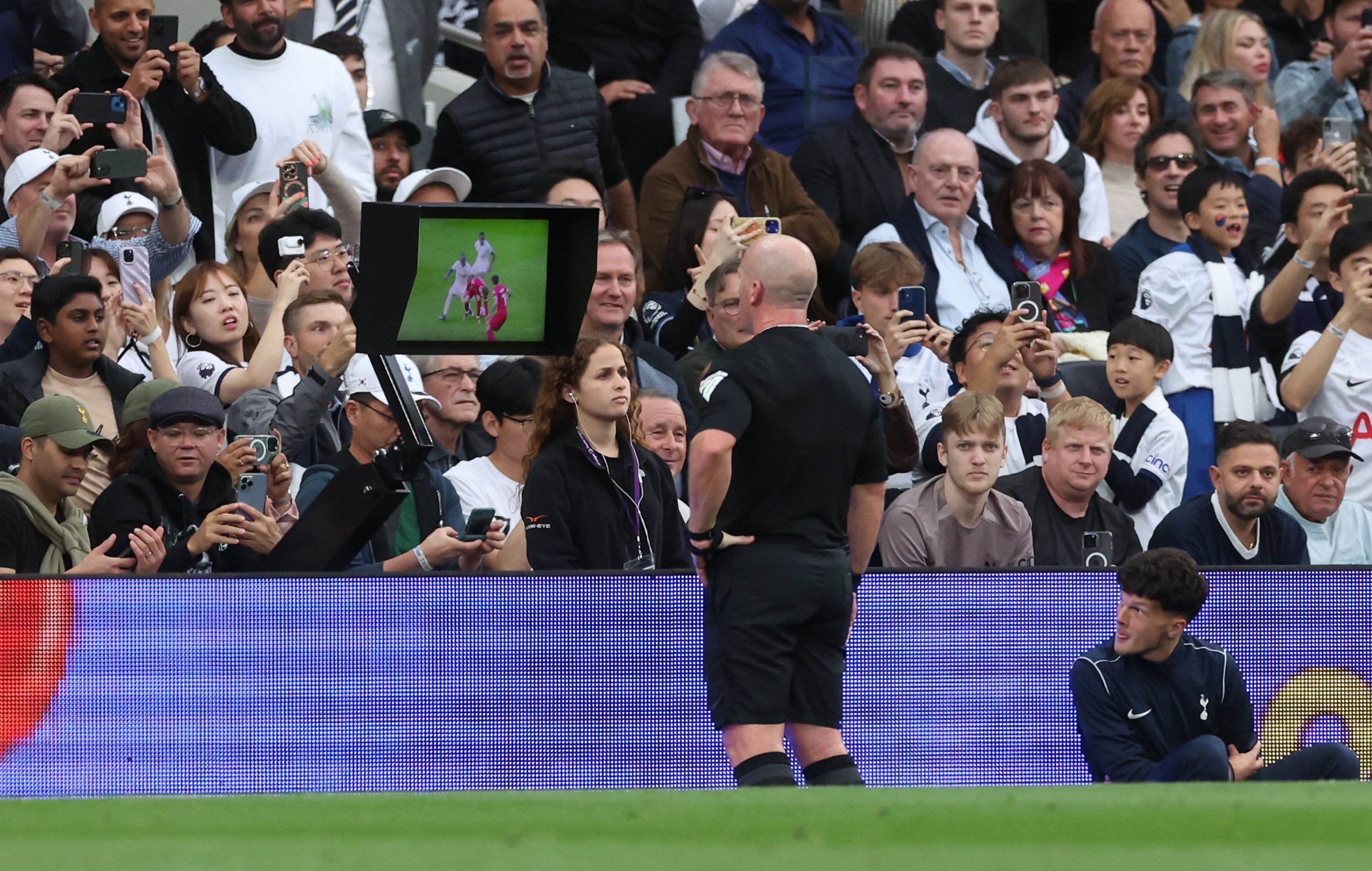 294584 Referee Simon Hooper (C) checks the VAR display before giving a red card to Liverpool's Curtis Jones during the English Premier League match between Tottenham Hotspur and Liverpool, London, UK., Sept. 30, 2023. (EPA Photo)