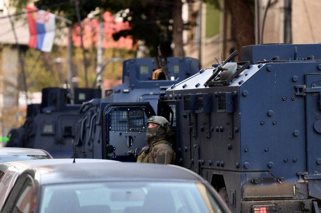 A police officer looks on as Kosovo police officers search a restaurant and building in the northern Serb-dominated part of the ethnically divided town of Mitrovica on Sept. 29, 2023. (AFP Photo)