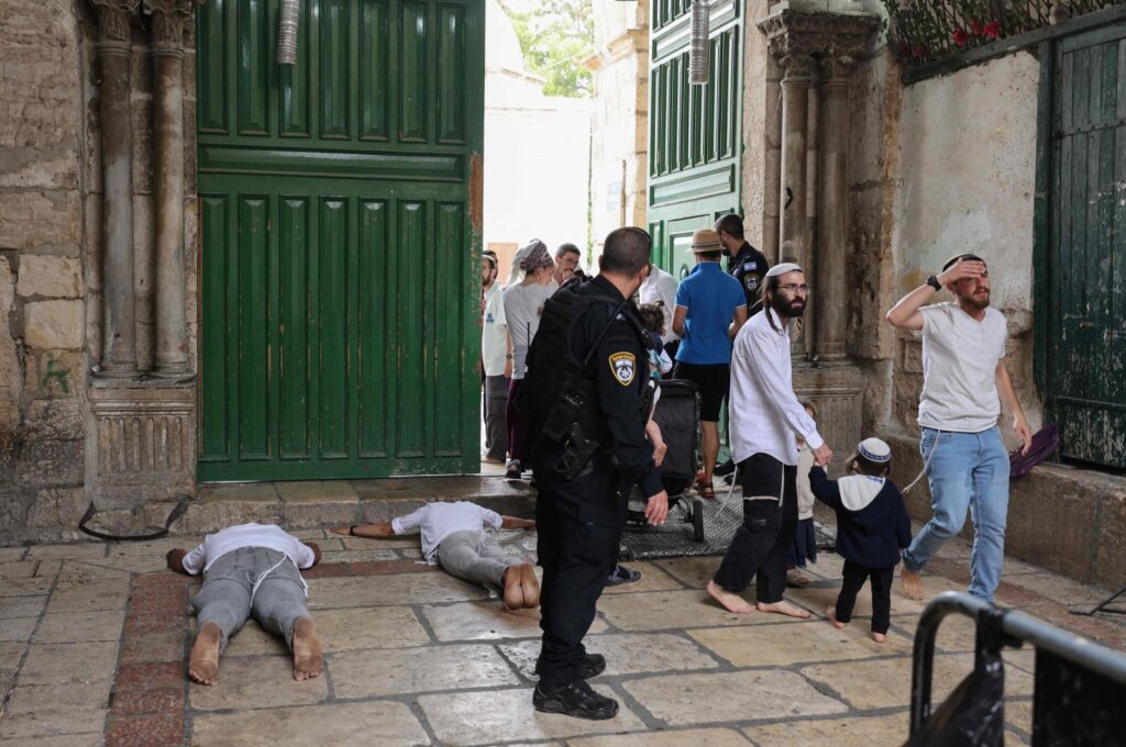 Jewish men prostrate on the ground in prayer outside the gate after a visit to the Haram al-Sharif (The Noble Sanctuary), (also known as Temple Mount) at one of the entrances of the al-Aqsa Mosque compound in the old city of Jerusalem, Oct. 2, 2023. (AFP Photo)