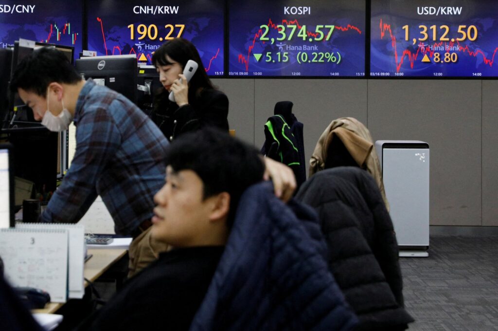 Currency dealers work in front of electronic boards showing the Korean Composite Stock Price Index (KOSPI) and the exchange rate between the U.S. dollar and South Korean won at a dealing room of a bank, Seoul, South Korea, March 16, 2023. (Reuters Photo)