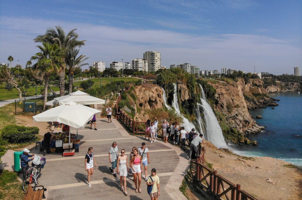 Tourists are seen walking close to the famous Düden Waterfalls, Antalya, southern Türkiye, Oct. 7, 2023. (IHA Photo)