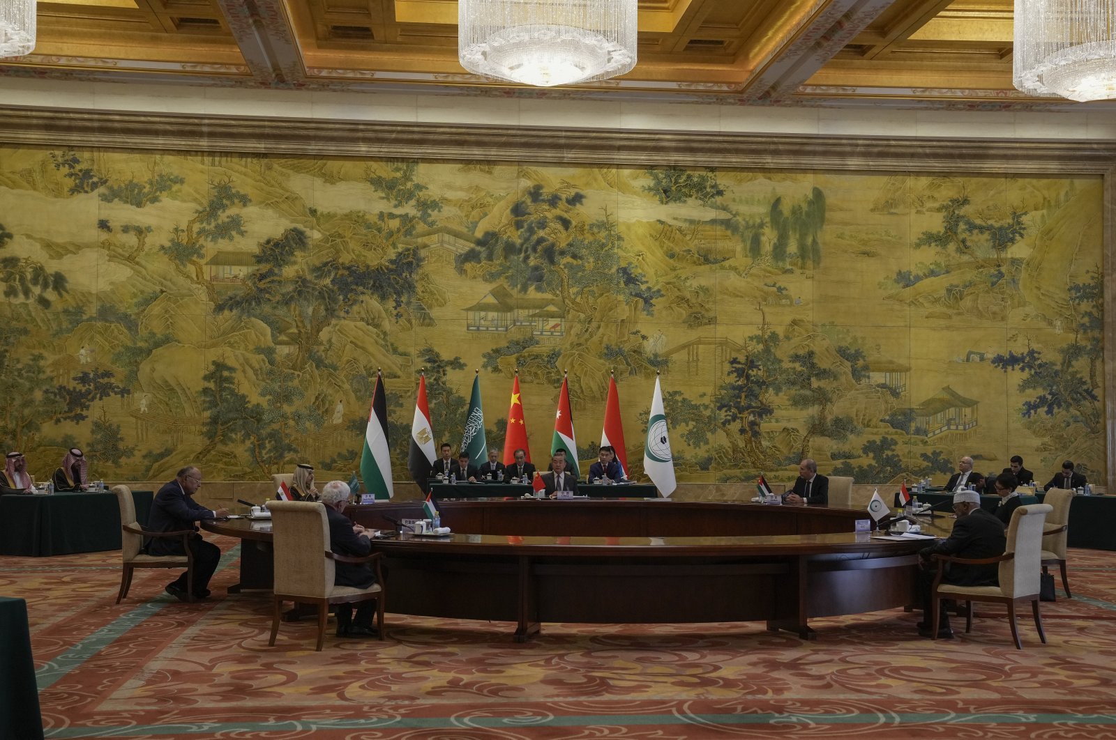 Chinese Foreign Minister Wang Yi (C) speaks during a round table meeting with five Arab and Islamic counterparts from center clock wise, Jordanian Deputy Prime Minister and Foreign Minister Ayman Safadi, Indonesian Foreign Minister Retno Marsudi, Secretary-General of the Organization of Islamic Cooperation (OIC) Hissein Brahim Taha, Palestine Foreign Minister Riyad al-Maliki, Egyptian Foreign Minister Sameh Shoukry and Saudi Arabia's Foreign Minister Faisal bin Farhan Al Saud at the Diaoyutai state guesthouse in Beijing, China, Nov. 20, 2023. (AP Photo)