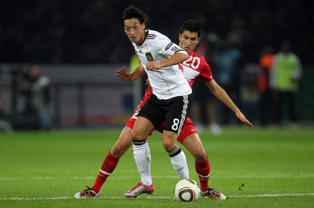 Germany's Mesut Özil (L) is challenged by Türkiye's Nuri Sahin during the Euro 2012 Group A qualifier match at Olympic Stadium, Berlin, Germany, Oct. 8, 2010.  (Getty Images Photo)