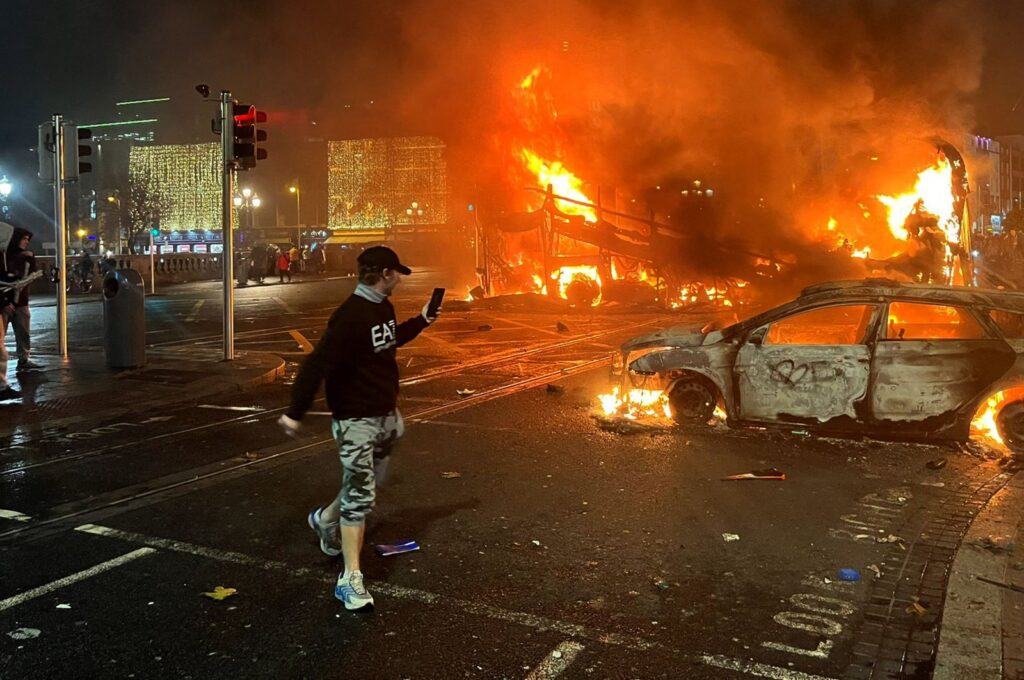 Flames rise from a car and a bus, set alight at the junction of Bachelors Walk and the O'Connell Bridge, Dublin, Ireland, Nov. 23, 2023. (AFP Photo)