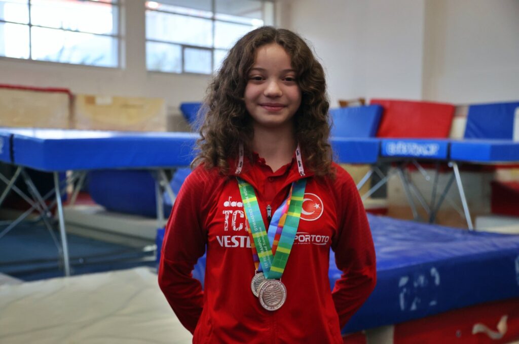 Turkish gymnast ,Tuba Bade Şahin poses for a photo with her medals, Istanbul, Türkiye, Nov. 26, 2023. (AA Photo)