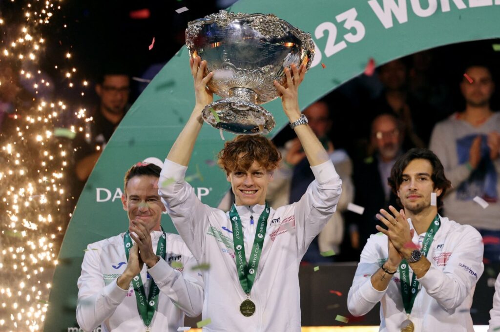 Italy's Jannik Sinner celebrates with the trophy and teammates after winning the Davis Cup Tennis following the Australia match at the Palacio de deportes Martin Carpena, Malaga, Spain, Nov. 26, 2023. (Reuters Photo)