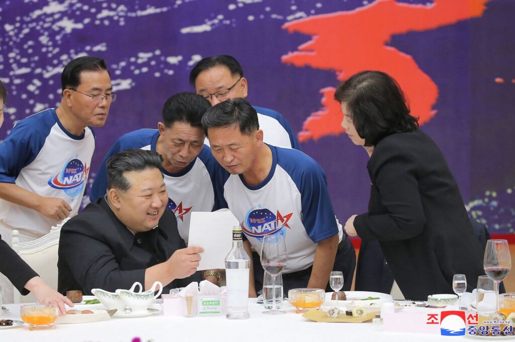 North Korea's leader Kim Jong Un (2nd L) chatting with senior officials of relevant departments at a banquet to celebrate the launch of a spy satellite, Pyongyang, North Korea, Nov. 23, 2023. (AFP Photo)