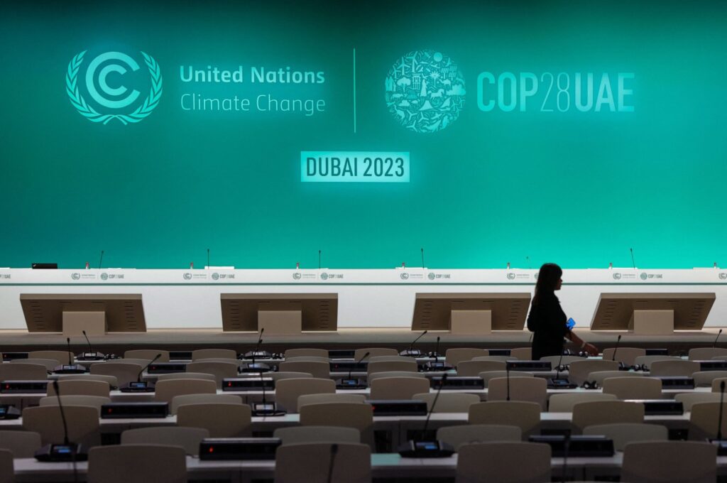 A woman walks in an empty conference room ahead of the COP28 United Nations climate summit in Dubai, UAE, Nov. 28, 2023. (AFP Photo)