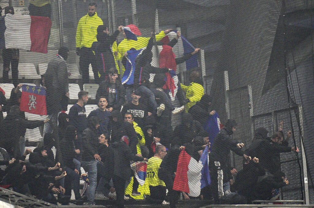 Lyon fans try to break the net on the stands prior to the French Ligue 1 match against Marseille, Velodrome Stadium, Marseille, France, Oct. 29, 2023. (AP Photo)