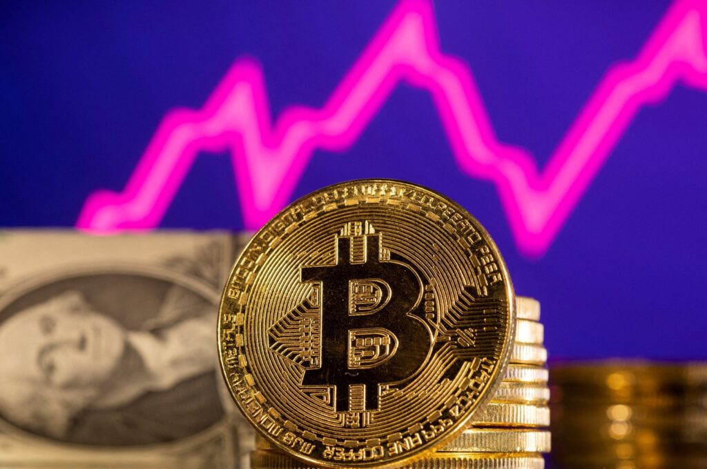 A representation of the cryptocurrency bitcoin is seen in front of a stock graph and U.S. dollar in this illustration taken, Jan. 24, 2022. (Reuters Photo)