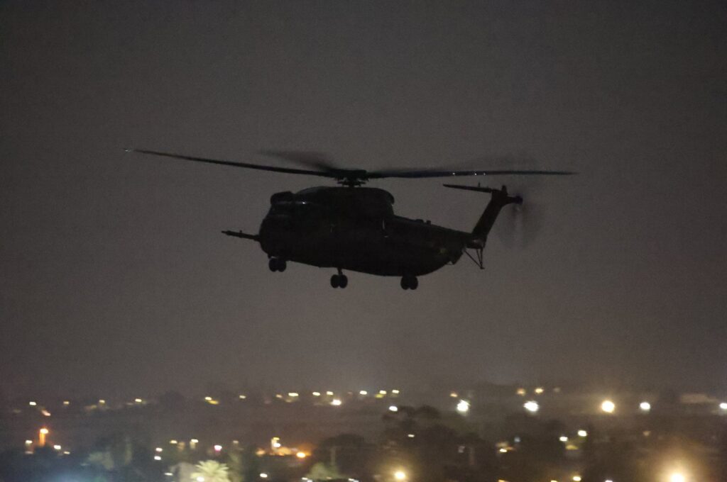 An Israeli army helicopter landing near the Kerem Shalom crossing between Gaza and Israel, Nov. 24, 2023. (EPA Photo)