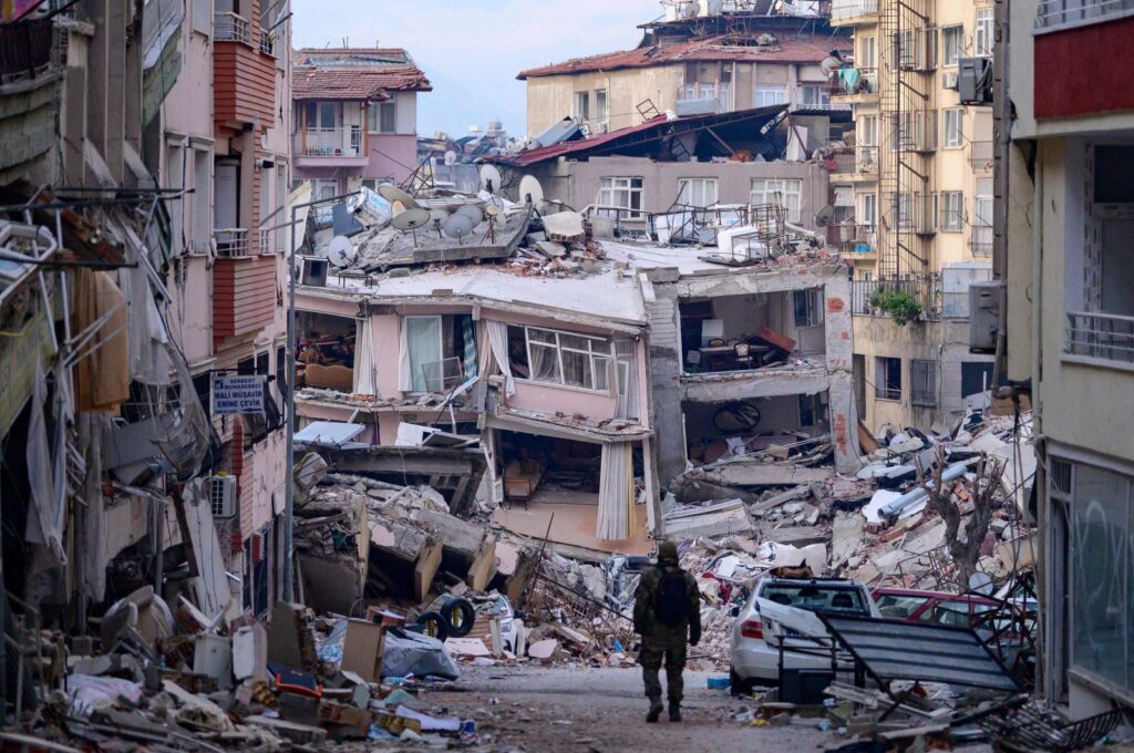 A Turkish soldier walks among destroyed buildings after a major earthquake in Hatay, southeastern Türkiye, Feb. 12, 2023. (AFP Photo)