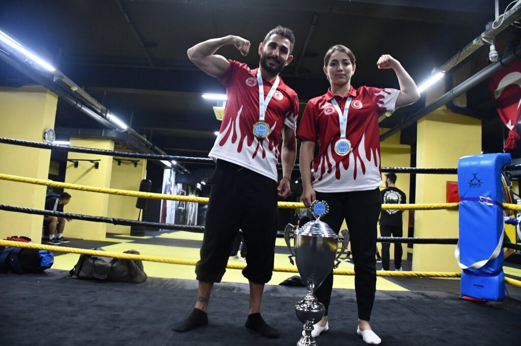Turkish kickboxers Emre Karaca (L) and Güler Deniz Topuz pose with a trophy, Darıca, Türkiye, Nov. 30, 2023. (AA Photo)