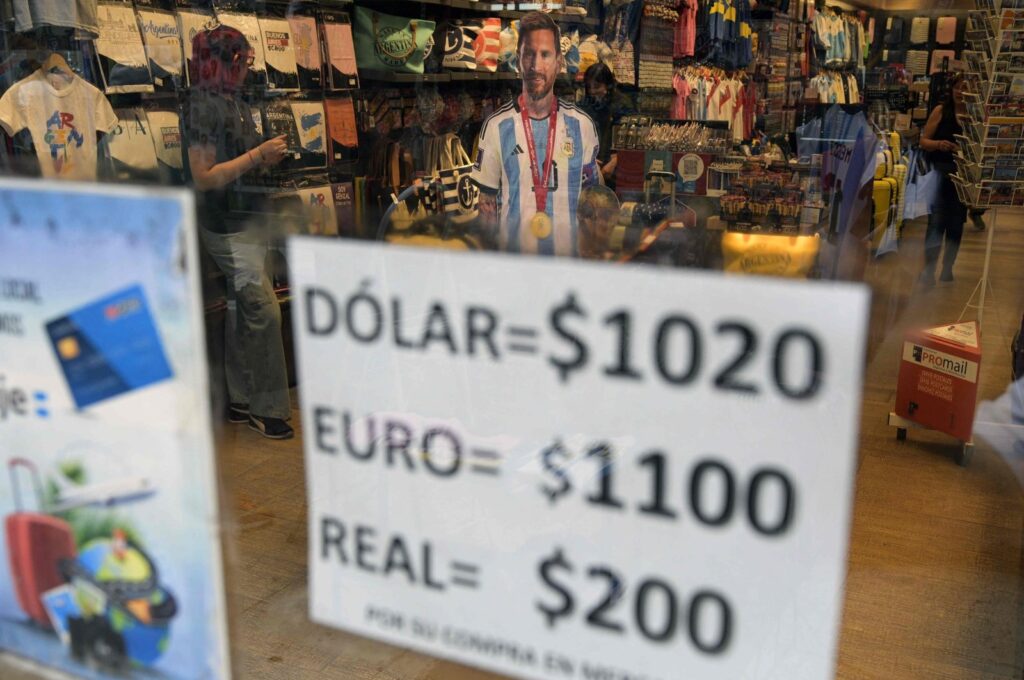 An image of Argentina's forward Lionel Messi is seen at a store displaying a sign with the exchange rate for U.S. dollars, euros and Brazilian reales in Argentine pesos, in Buenos Aires, Argentina, Nov. 21, 2023. (AFP Photo)