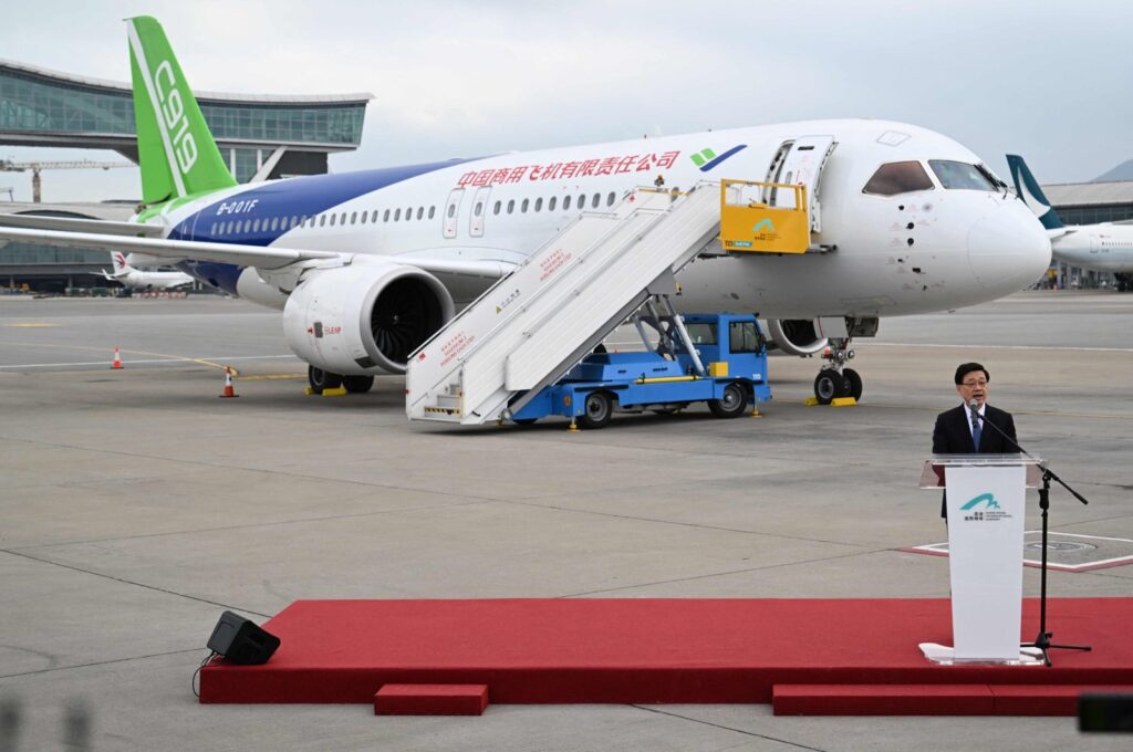 Hong Kong Chief Executive John Lee speaks in front of China's domestically produced C919 passenger jet while on display to the media at Hong Kong International Airport, Hong Kong, China, Dec. 13, 2023. (AFP Photo)