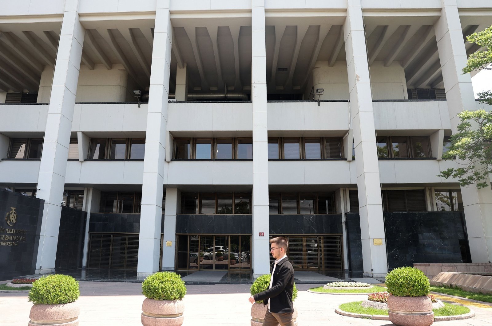 A pedestrian walks by the headquarters of the Central Bank of the Republic of Türkiye (CBRT), Ankara, Türkiye, June 9, 2023. (AFP Photo)