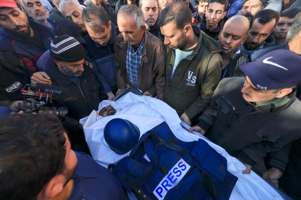People mourn over the body of Al Jazeera cameraman Samer Abu Daqa, who was killed during Israeli bombardment, Khan Yunis, southern Gaza Strip, Palestine, Dec. 16, 2023. (AFP Photo)