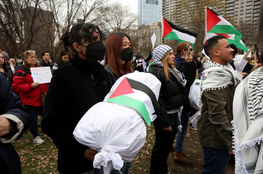 A demonstrator holds a replica of a dead Palestinian child wrapped in a burial shroud at a rally in Boston, U.S., Dec. 17, 2023. (Reuters Photo)
