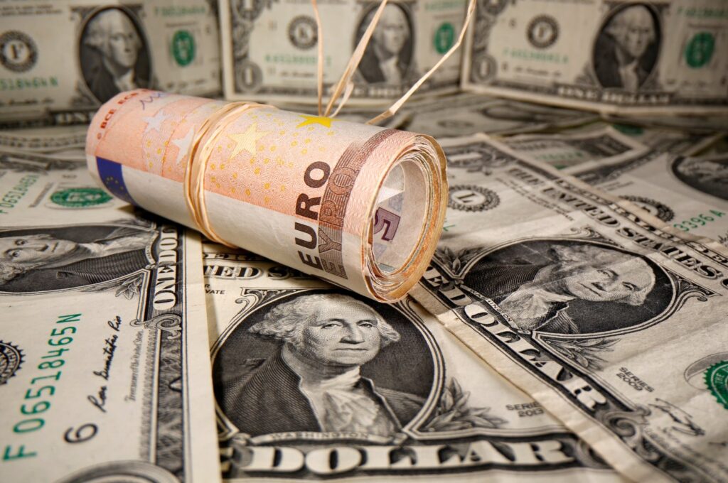 Rolled euro banknotes are placed on U.S. dollar banknotes in this illustration taken May 26, 2020. (Reuters Photo)