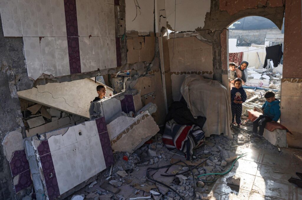 Palestinian youths are seen in the rubble of a damaged house in Rafah in the southern Gaza Strip, Palestine, Dec. 18, 2023. (AFP Photo)