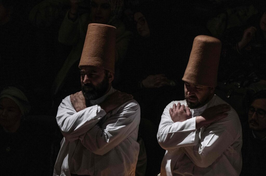 Whirling dervishes, wearing the symbolic hat "sikke", perform the "Sema" ritual as part of a ceremony to celebrate the 750th anniversary of the death of Mevlana Jalaluddin Rumi, 13th-century Islamic poet, scholar, and Sufi mystic, at Mevlana Cultural Center in Konya, Türkiye, Dec. 17, 2023. (AFP Photo)