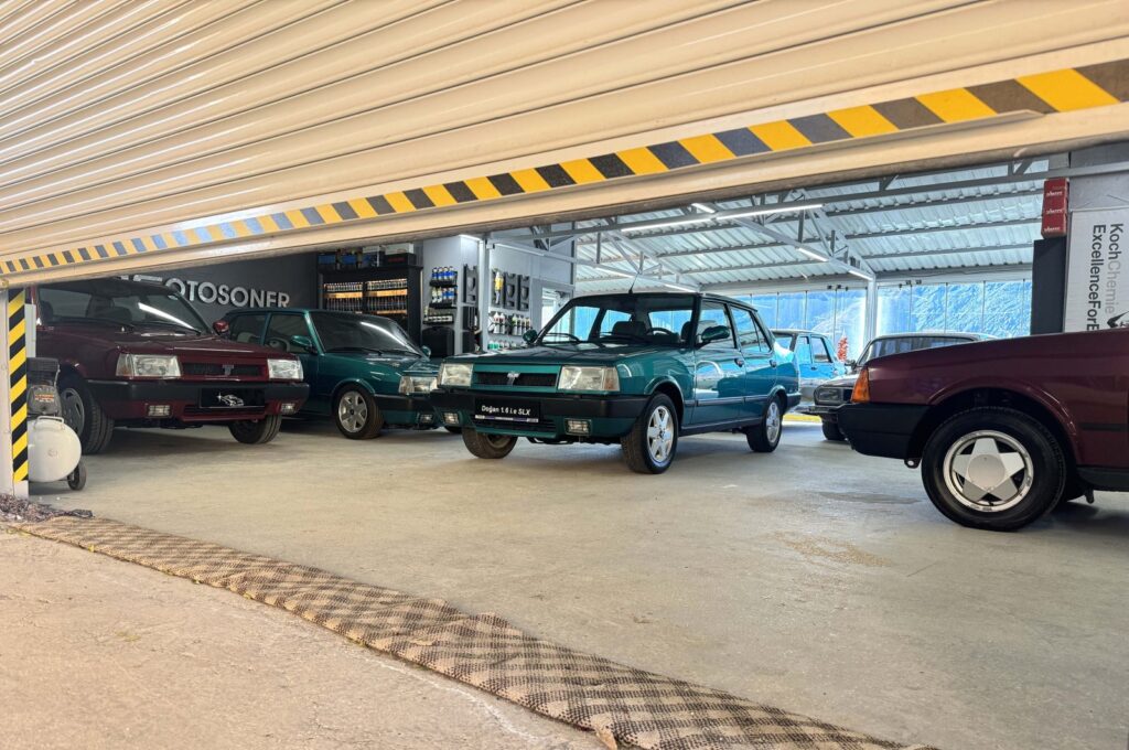 Classic cars can be seen behind a half-closed garage door of the Çağıran brothers' apartment terrace classic car garage, Maden, Elazığ, Türkiye, Dec. 16, 2023. (AA Photo)