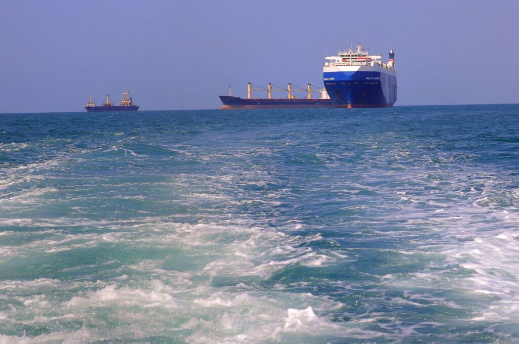A picture taken during an organized tour by Yemen's Houthi rebels on Nov.22, 2023, shows the Galaxy Leader cargo ship (R), seized by Houthis two days earlier, approaching the port in the Red Sea off Yemen's province of Hodeida. (AFP Photo)