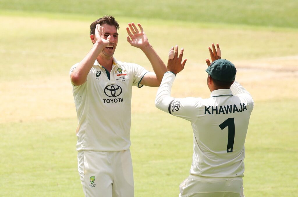 Australia's Pat Cummins celebrates a wicket with teammate Usman Khawaja during Day 3 of the Men's First Test match against Pakistan at Optus Stadium Perth, Australia, Dec. 16, 2023. (Getty Images Photo)