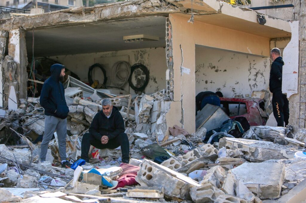 Men check the rubble of a building following an Israeli bombardment, Bint Jbeil, southern Lebanon, Dec. 27, 2023. (AFP Photo)