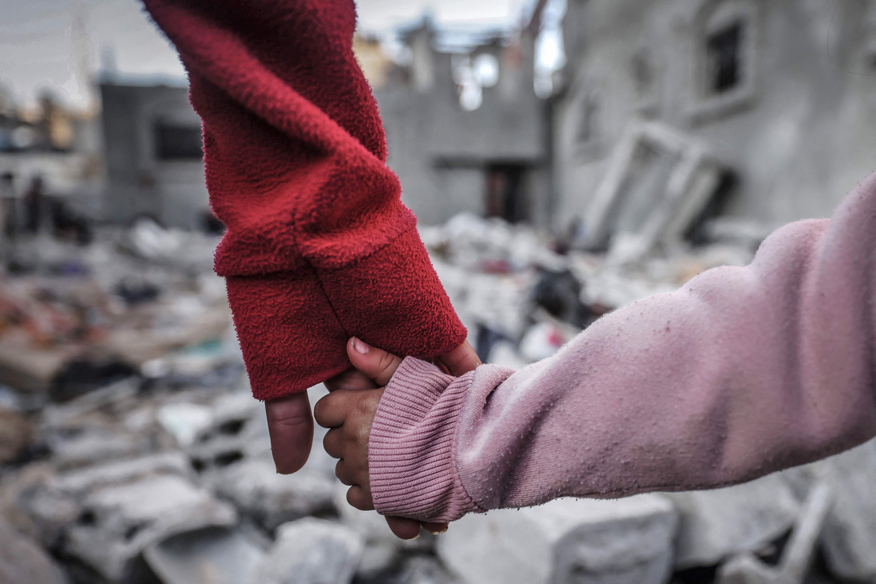 307769 People hold hands as they inspect the damage on buildings destroyed during Israeli bombardment in Rafah, southern Gaza Strip, Palestine, Dec. 29, 2023. (AFP Photo)