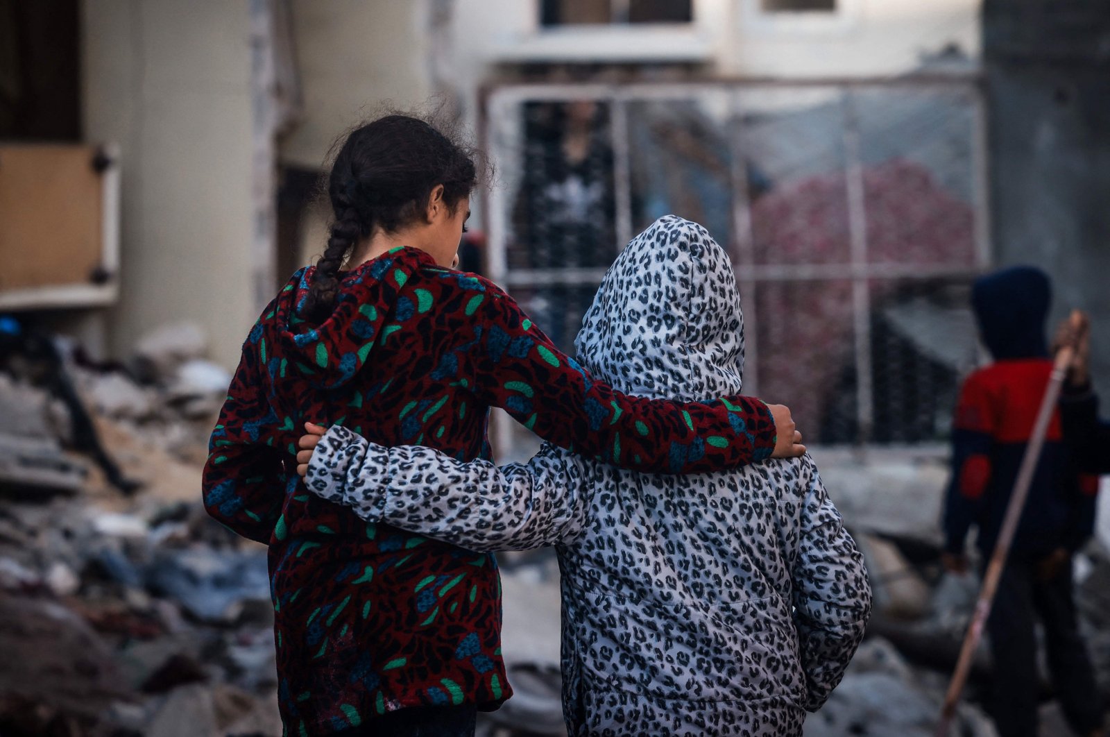 Children embrace as people inspect the damage following Israeli bombardment in Rafah, southern Gaza Strip, Palestine, Dec. 29, 2023. (AFP Photo)