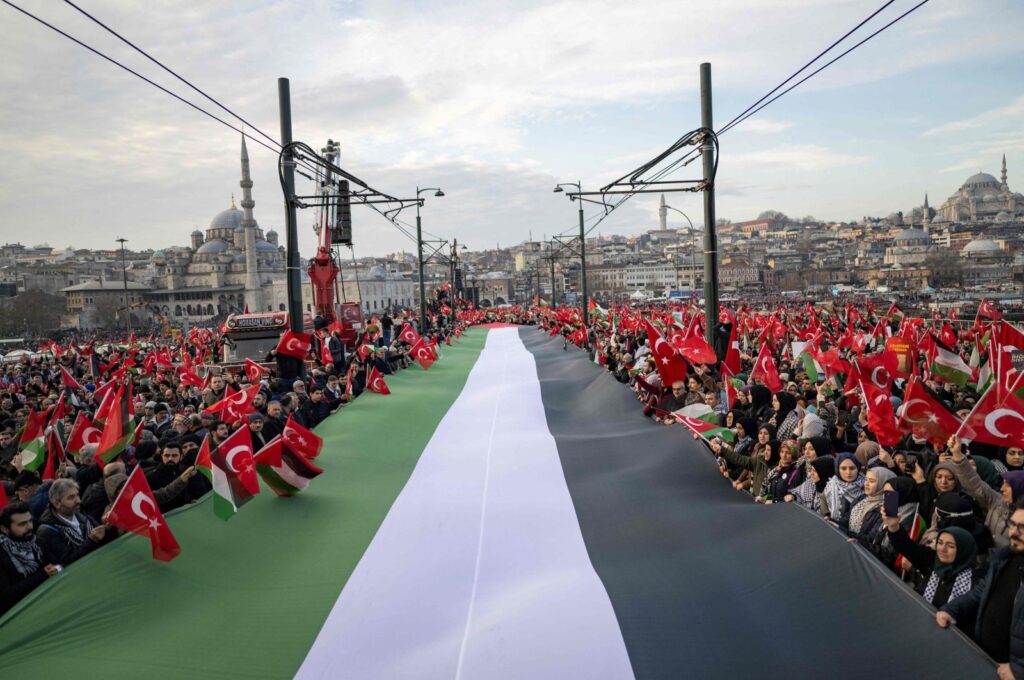 Holding a huge Palestinian flag, thousands demonstrate to show solidarity with the Palestinian people amid Israel's indiscriminate attacks on the Gaza Strip that have claimed over 20,000 lives, Galata Bridge, Istanbul, Türkiye, Jan 1, 2024. (AFP Photo)