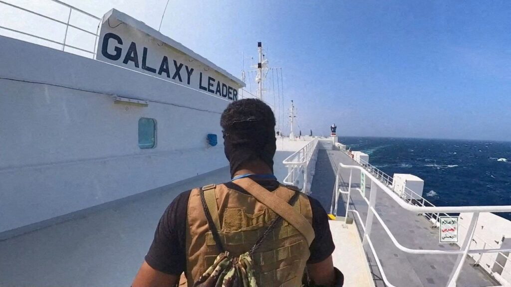 A Houthi fighter stands on the Galaxy Leader cargo ship in the Red Sea in this photo released Nov. 20, 2023. (Houthi Military Media/Handout via Reuters)