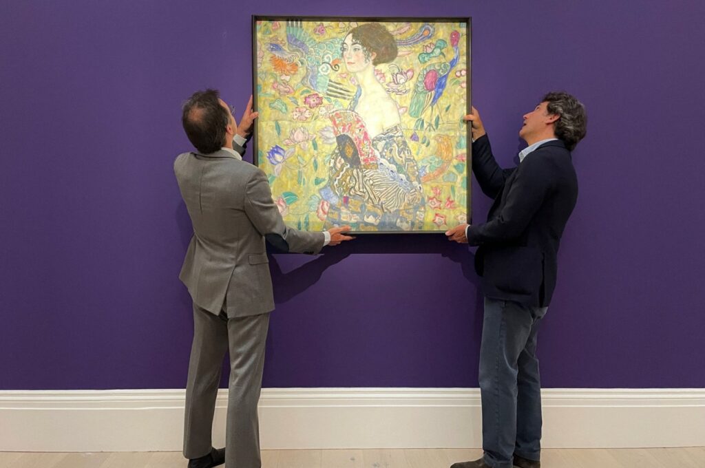 Employees pose with an artwork entitled"Lady with a Fan" by Austrian artist Gustav Klimt, during a photocall at Sotheby's auction house in central London, U.K., June 20, 2023. (Reuters Photo)