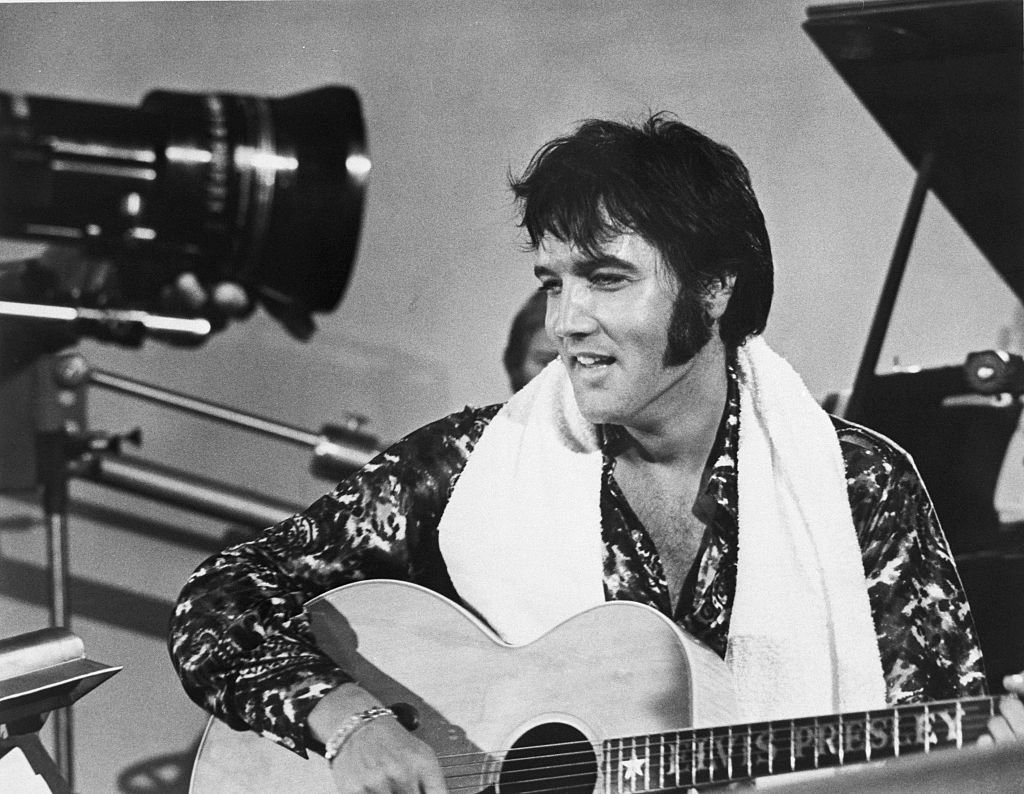 Elvis Presley plays guitar during a scene from the documentary film Elvis: That's the Way It Is. (Getty Images Photo)