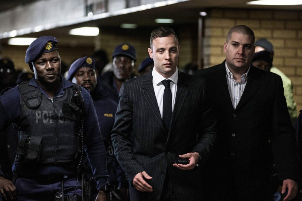 South African ex-Paralympian Oscar Pistorius (C) is surrounded by policemen as he arrives at Pretoria High Court to attend a sentencing hearing set to send him back to jail for murdering his girlfriend Reeva Steenkamp, Pretoria, South Africa, June 13, 2016. (AFP Photo)