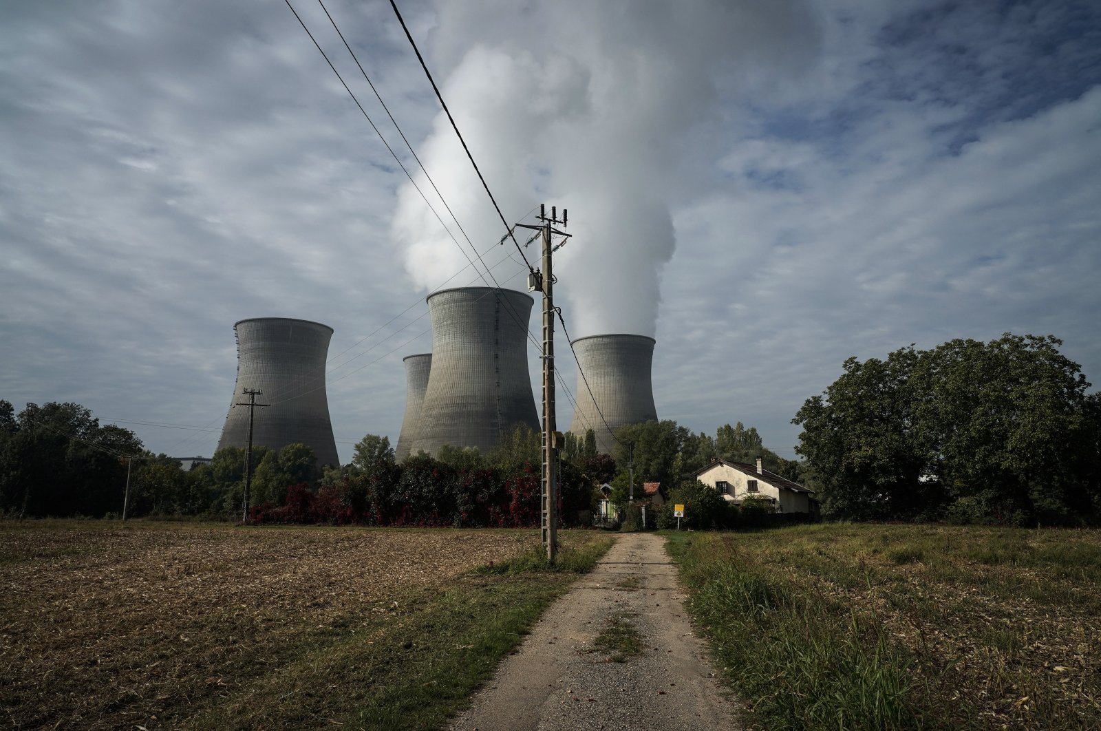 Water vapor rises from the cooling towers of the Bugey nuclear plant, in Saint-Vulbas, around Lyon, central France, Oct. 13, 2022. (AP Photo)