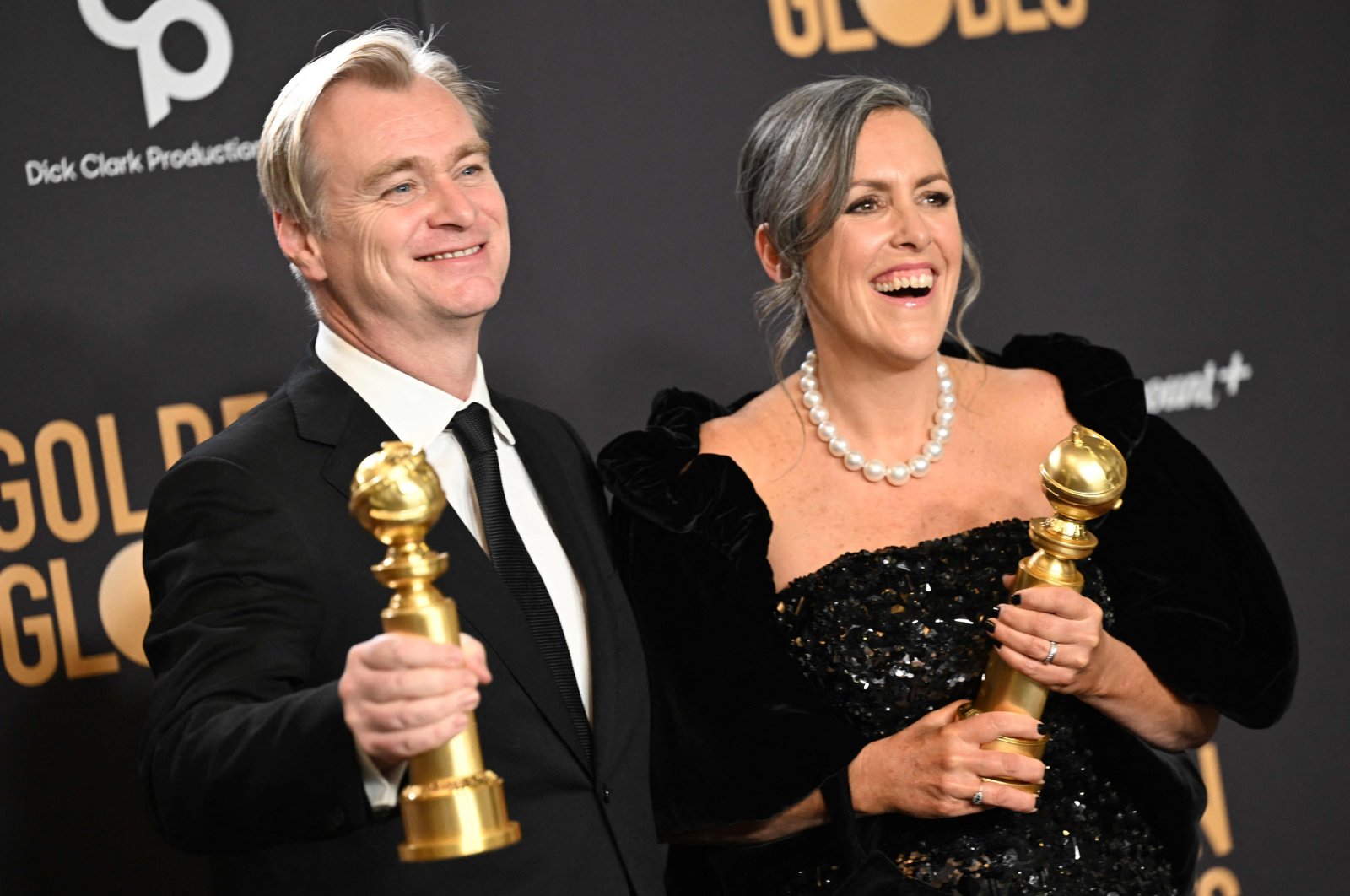 British director Christopher Nolan (L) and spouse British film producer Emma Thomas pose in the press room with the awards for Best Director - Motion Picture and Best Motion Picture - Drama for "Oppenheimer" during the 81st annual Golden Globe Awards, Beverly Hills, California, U.S., Jan. 7, 2024. (AFP Photo)